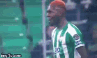 a man with red hair is wearing a green and white striped shirt that says go on it
