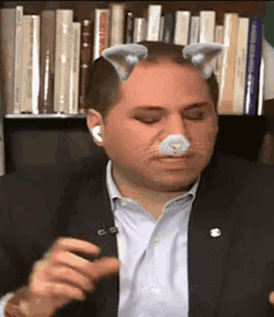 a man in a suit has a cat ear on his face