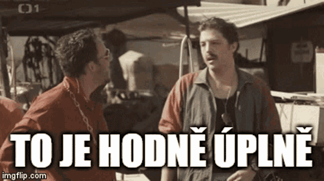 two men standing next to each other with the words to je hodne uplne written on the screen