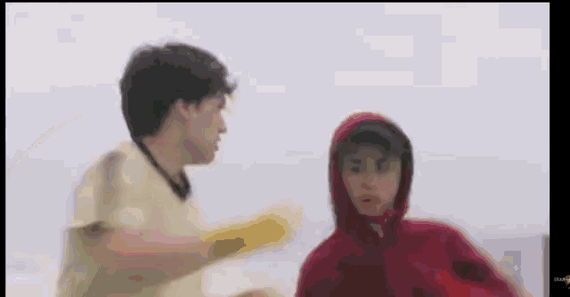 a man and a woman are standing next to each other in a blurry photo .