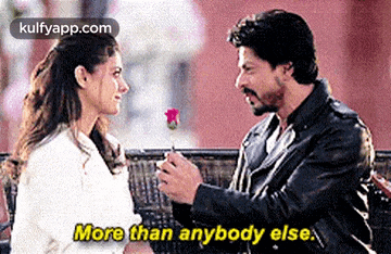 a man is giving a rose to a woman on a bench and says `` more than anybody else '' .