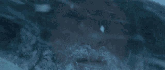 a close up of a person 's face surrounded by smoke