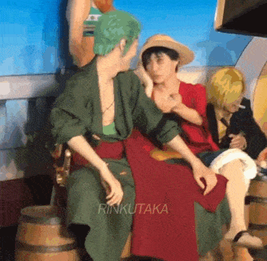 two men in one piece costumes are sitting next to each other on a chair .