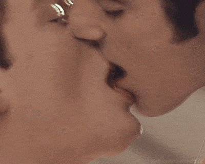a close up of two men kissing with the words xbeyondangelsxx on the bottom