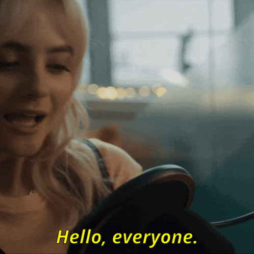 a woman is looking at herself in a mirror and the words hello everyone are above her
