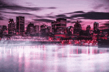 a city skyline with a purple sky in the background and a body of water in the foreground