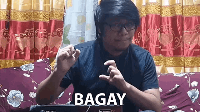 a man sitting on a couch with bagay written on the front of him