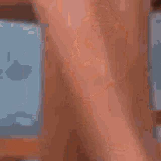 a close up of a person 's face with a pink item in the background