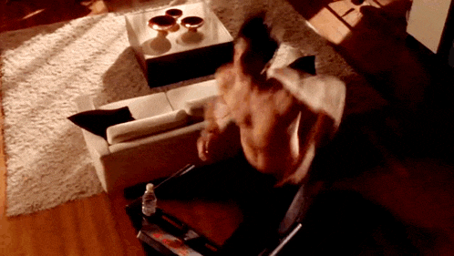 a man runs on a treadmill in a living room