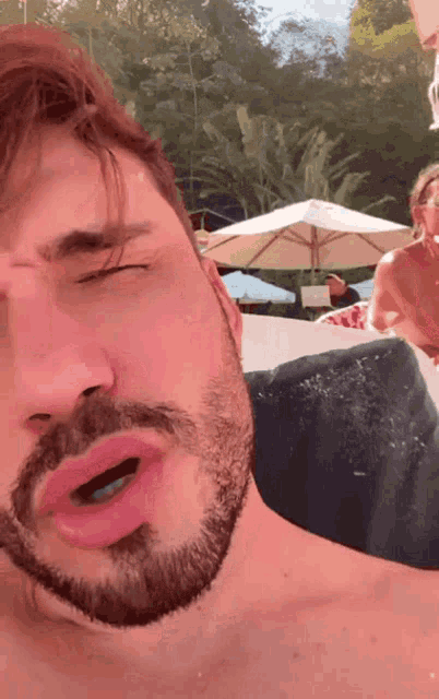 a man with a beard is making a face with his mouth open