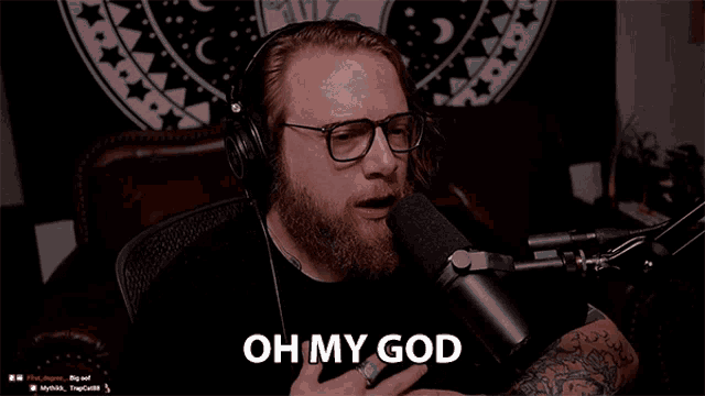 a man with glasses and headphones is talking into a microphone and says " this is amazing "