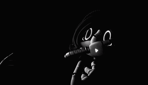 a black and white image of a robot with a sad face on its eyes