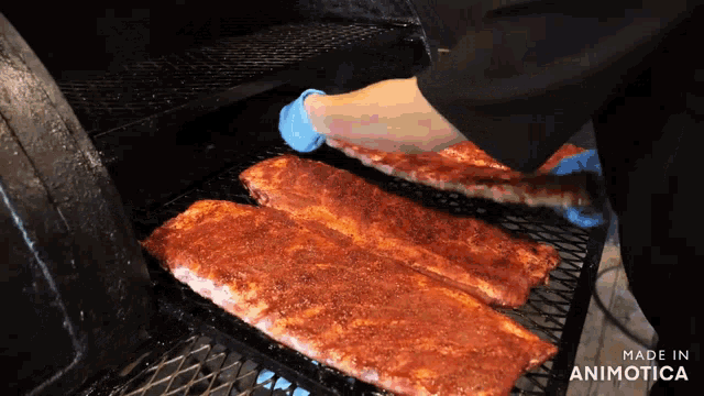 ribs are being cooked in a smoker with the words made in animotica below them