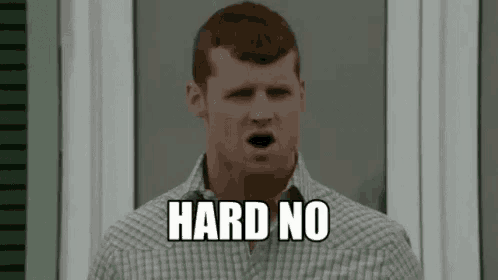a man in a plaid shirt is standing in front of a window with his mouth open and the words `` hard no '' on his face .