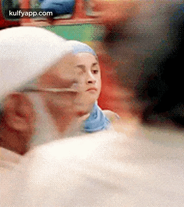 a blurry picture of a man and a woman looking at something .
