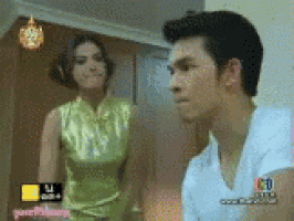 a man and a woman are standing next to each other on a television screen
