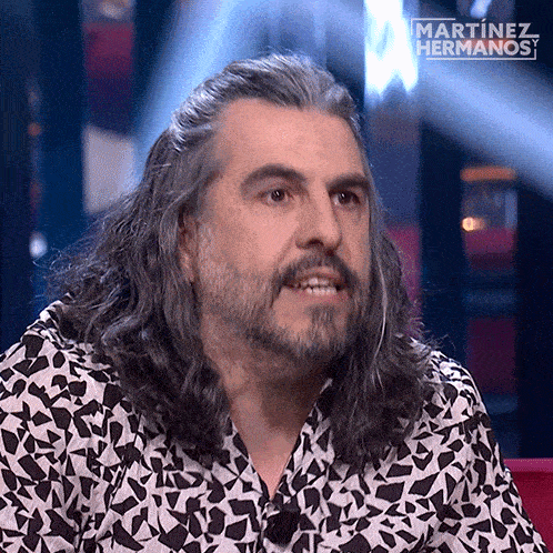 a man with long hair and a beard is on a martinez hermanos show