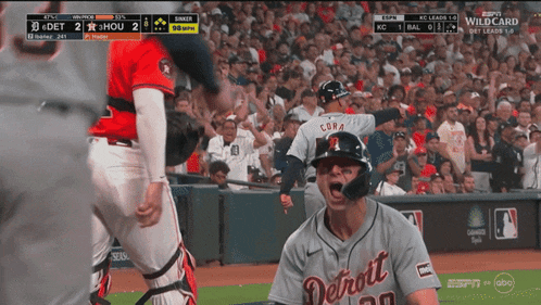 a man in a detroit baseball uniform is yelling at another man