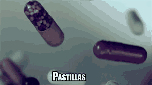 a bunch of pills are falling in the air and the word pastillas is on the bottom of the screen .