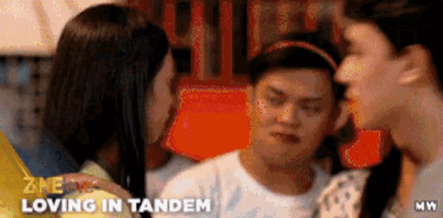 a man is being kissed on the cheek by two women with the words loving in tandem written on the bottom