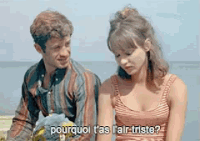a man and a woman are sitting next to each other and the woman says pourquoi t'as l'air triste