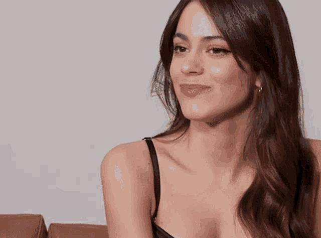 a woman in a black bra is smiling and laughing