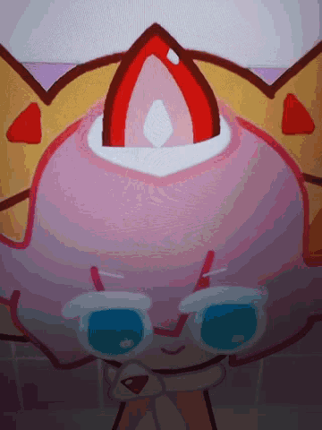a close up of a pink cartoon character with a yellow crown on its head