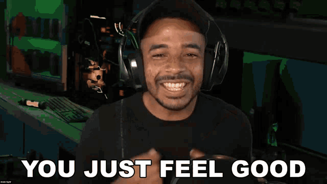 a man wearing headphones with the words you just feel good behind him