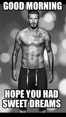 a shirtless man with tattoos on his arms and legs is standing in front of a blurry background .