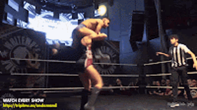 a wrestler is being lifted in the air by another wrestler