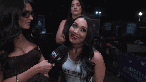a woman holding a microphone with a w on it