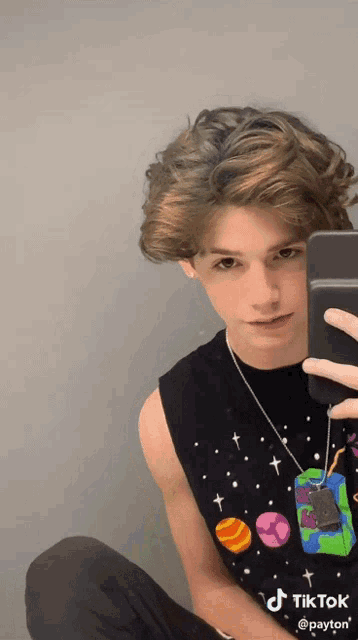 a young man is taking a picture of himself with a cell phone with the hashtag tiktok on the bottom