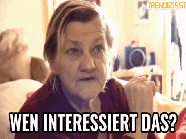 a woman with a cigarette in her mouth says wen interessiert das ?