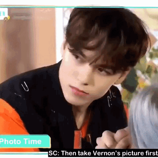 a close up of a person 's face with a caption that says `` then take vernon 's picture first ''