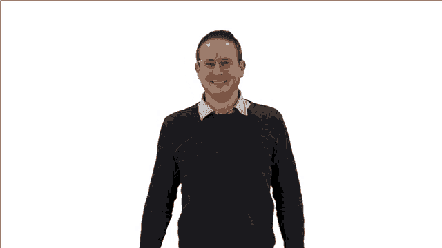 a man wearing glasses and a blue sweater is pointing at something