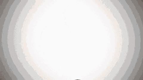 a man with a beard is standing in front of a white background and looking at the camera .