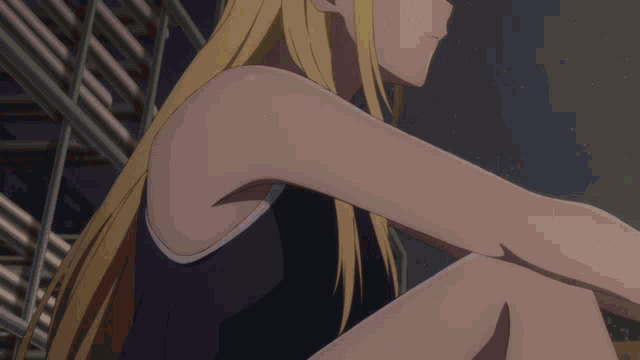a girl with long blonde hair is wearing a black tank top with white trim