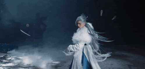 a woman with long white hair is wearing a white fur coat