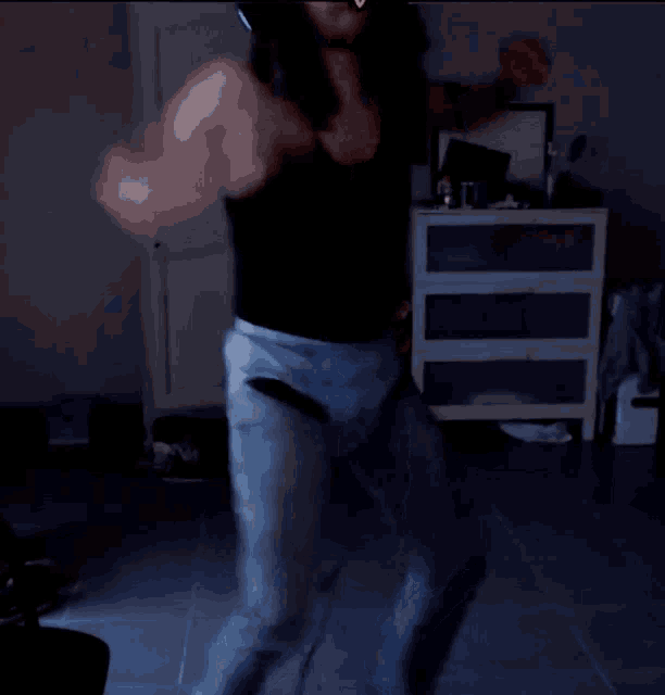 a blurry picture of a man dancing in a dark room