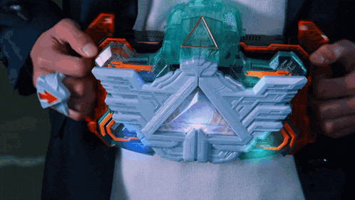 a person is holding a toy that looks like a pyramid