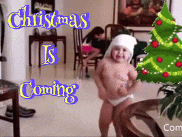 a baby in a diaper dancing in front of a christmas tree with the words christmas is coming