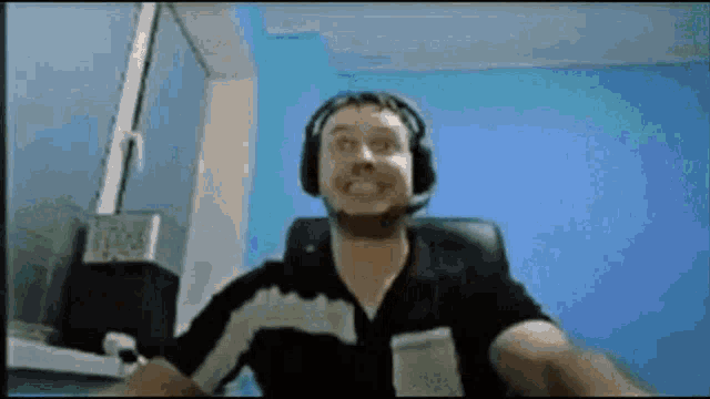 a man wearing headphones is sitting in a chair .