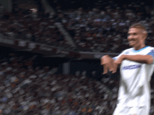 a soccer player wearing a white jersey with the word soccer on the front
