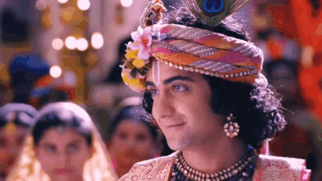 a man with a peacock feather on his head