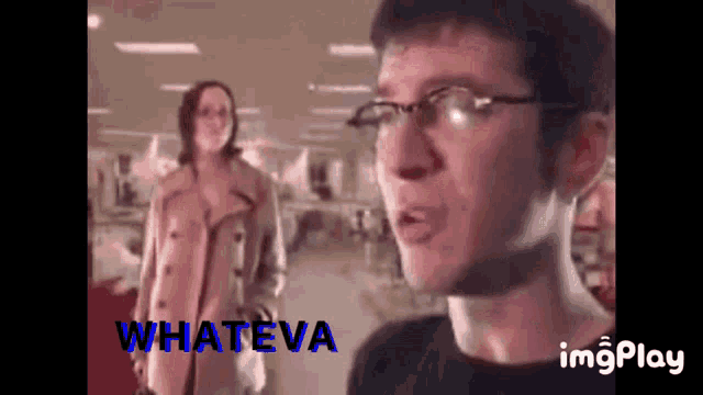 a man wearing glasses is talking to a woman in a trench coat while the words whateva are on the bottom