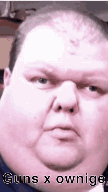 a close up of a fat man 's face with the words guns x ownige written on it .