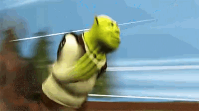 shrek is running with a sword in his mouth .