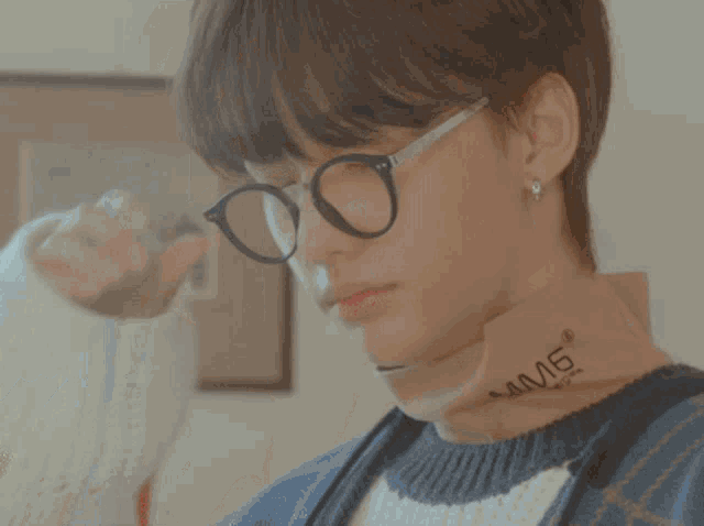 a person wearing a sweater with the letter n on the sleeve