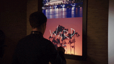 a man writes the name ward on a screen