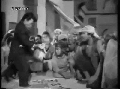 a group of people are gathered around a table in a black and white photo with the words m valley on the bottom .